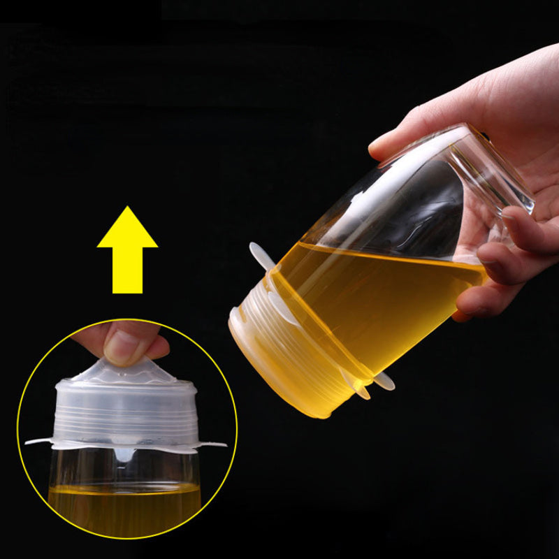Hand holding a clear container with a yellow liquid, showing the lid being opened.