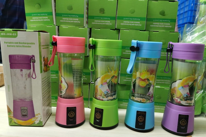 Four colorful portable blenders with packaging in the background