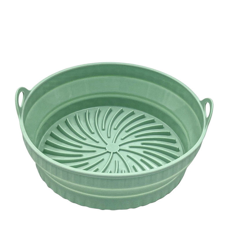 Green collapsible colander on a white background