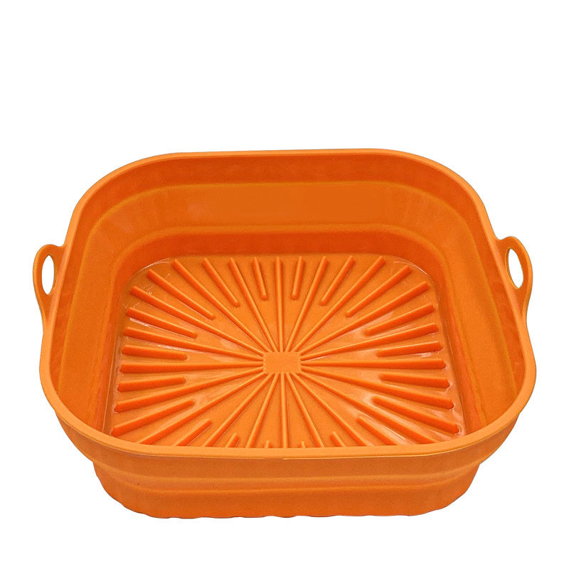 Orange silicone baking dish with handles on a white background