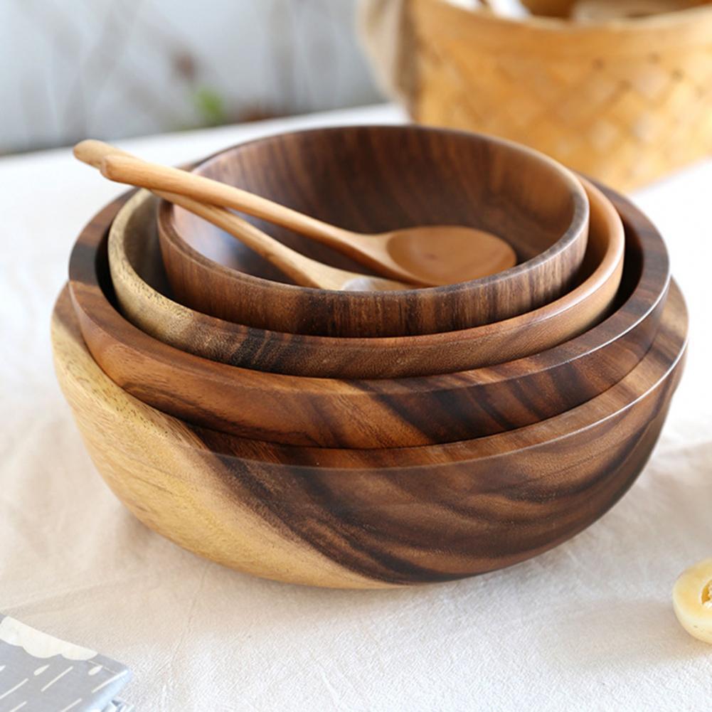Set of wooden bowls with a spoon on table