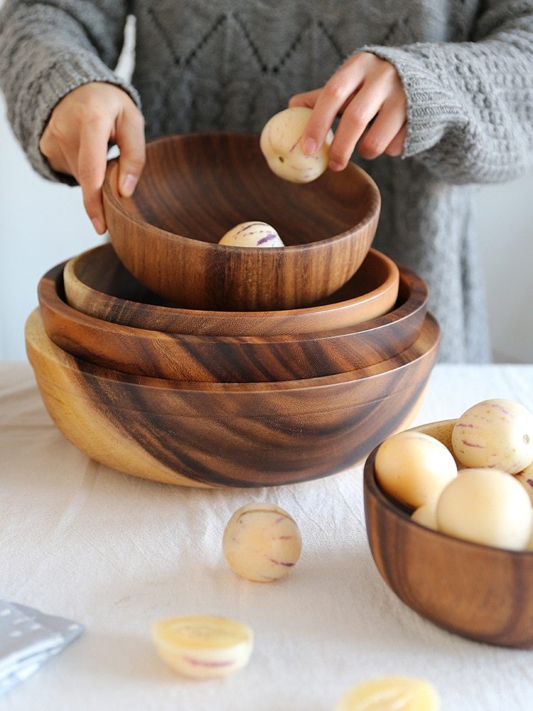 Stack of wooden bowls with eggs on the table